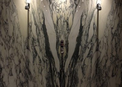 Bookmatched Nero Marquina and Arabescato Corchia Marble Walls with Brazilian Slate Floor